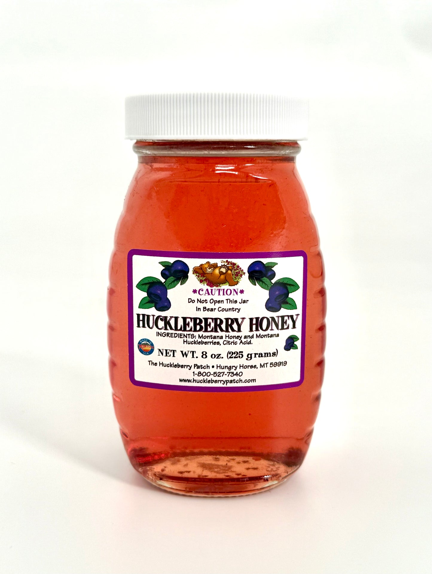 Glass jar of sweet golden huckleberry honey
