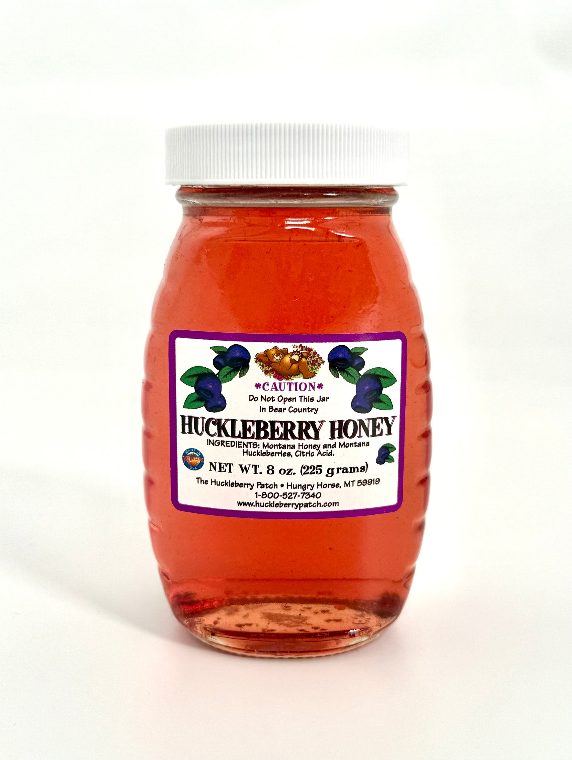 Glass jar of sweet golden huckleberry honey