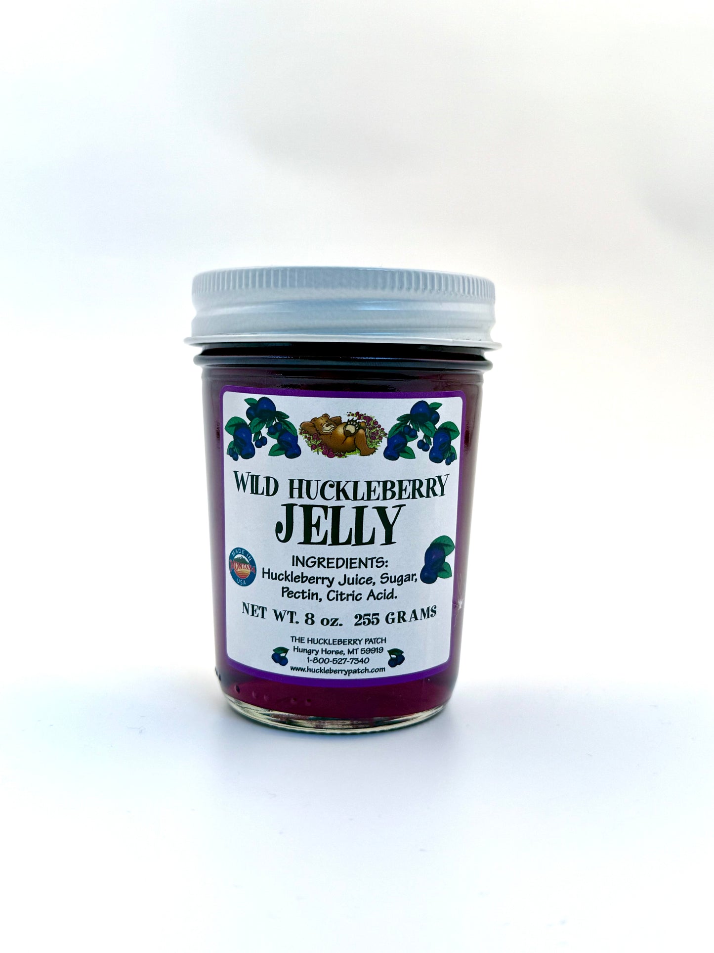 8oz jar of clear huckleberry jelly, deep purple color in glass jar