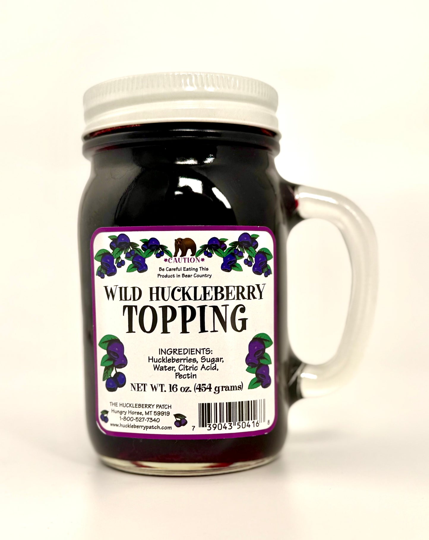 Large 16oz jar of huckleberry topping with berry-filled contents visible