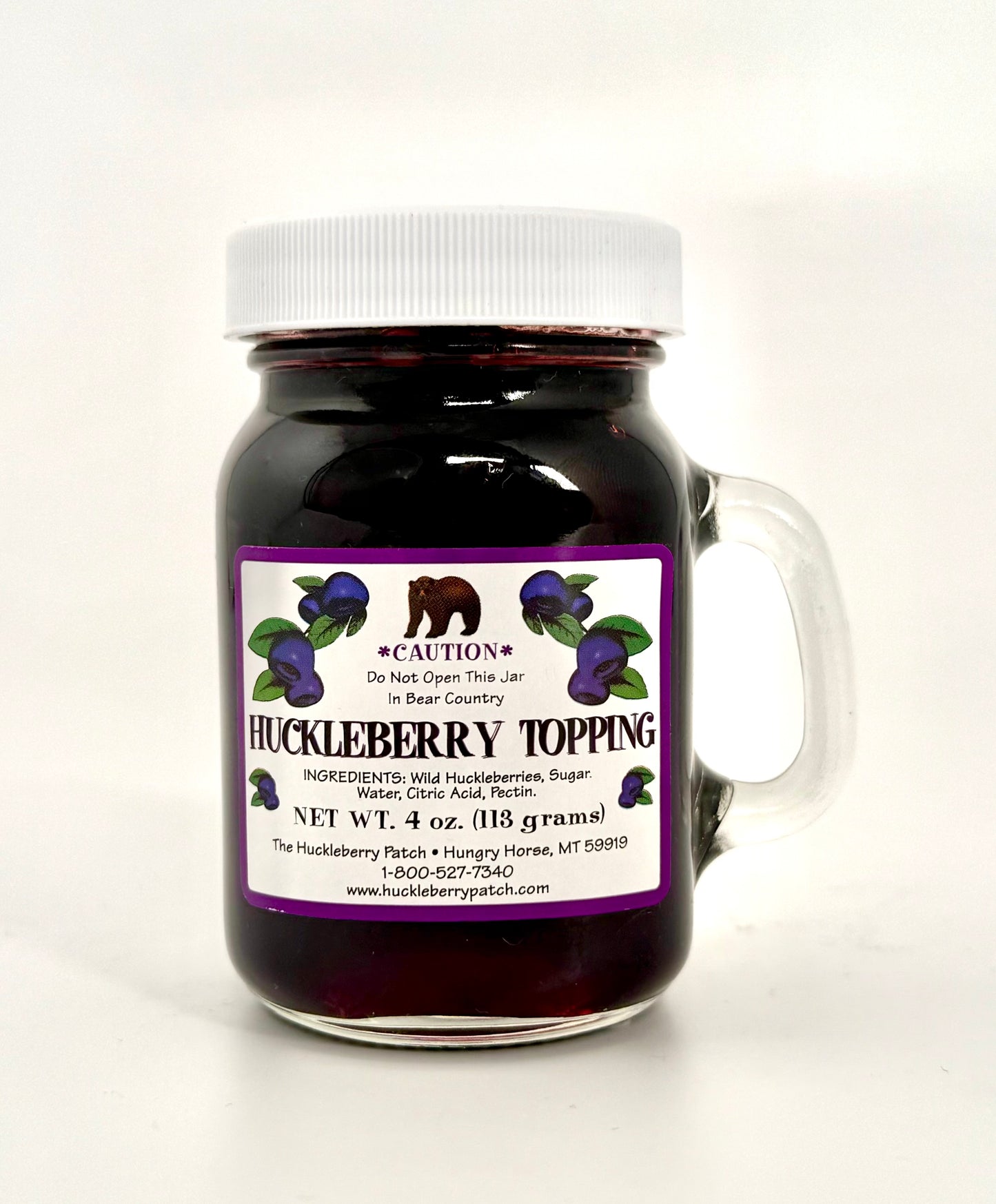 Small 4oz jar of huckleberry topping with front label visible