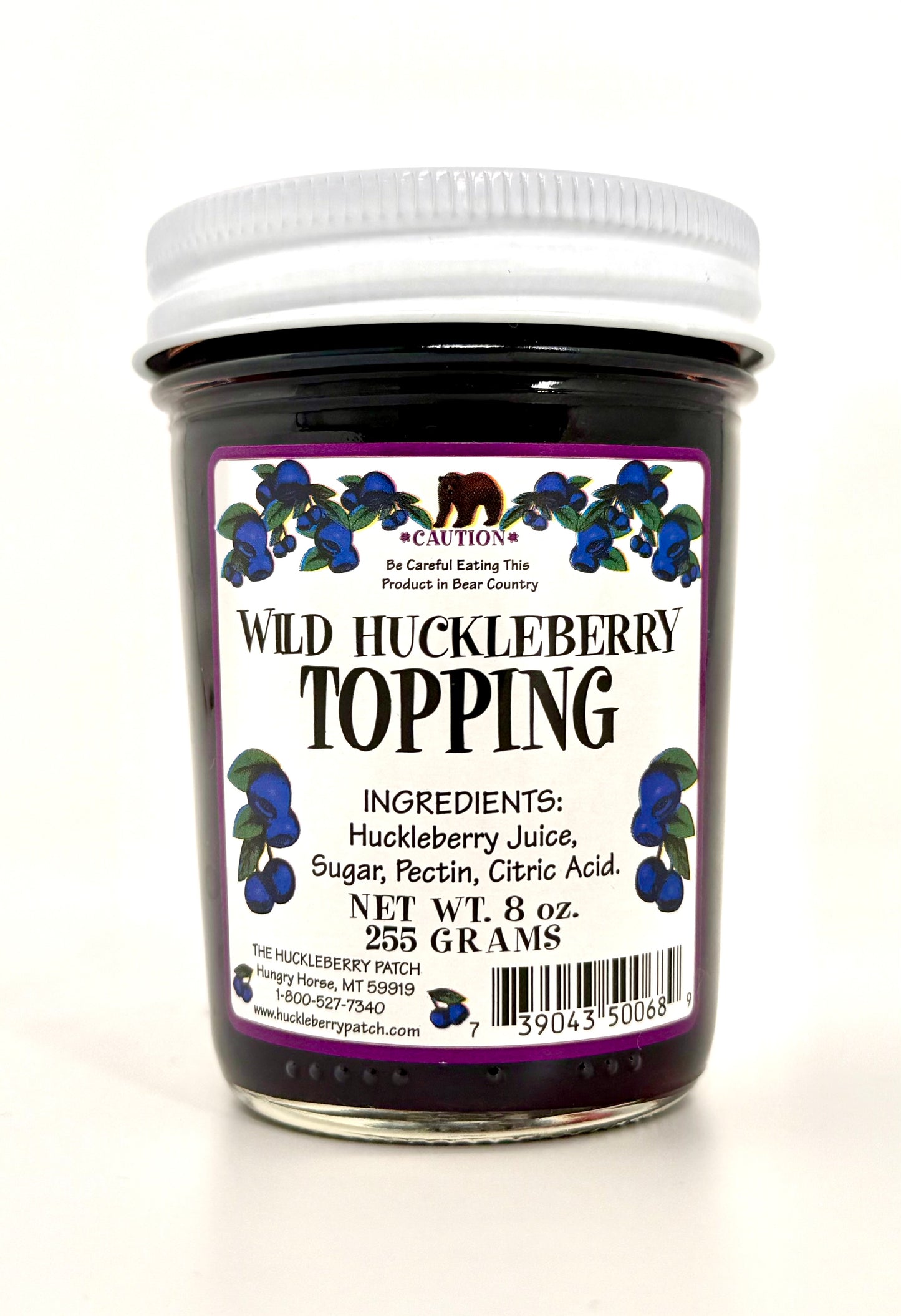 Tall 8oz jar of huckleberry topping, clear glass showing berries