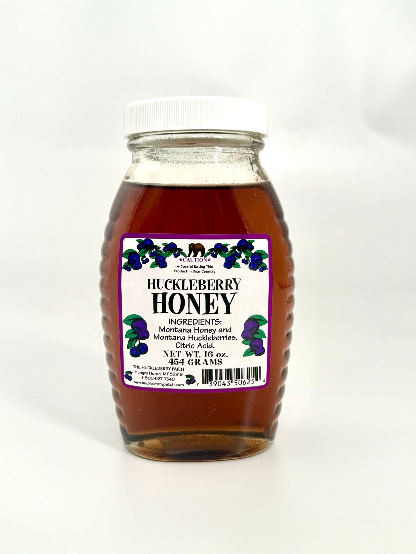 Smooth sweet huckleberry honey in large jar