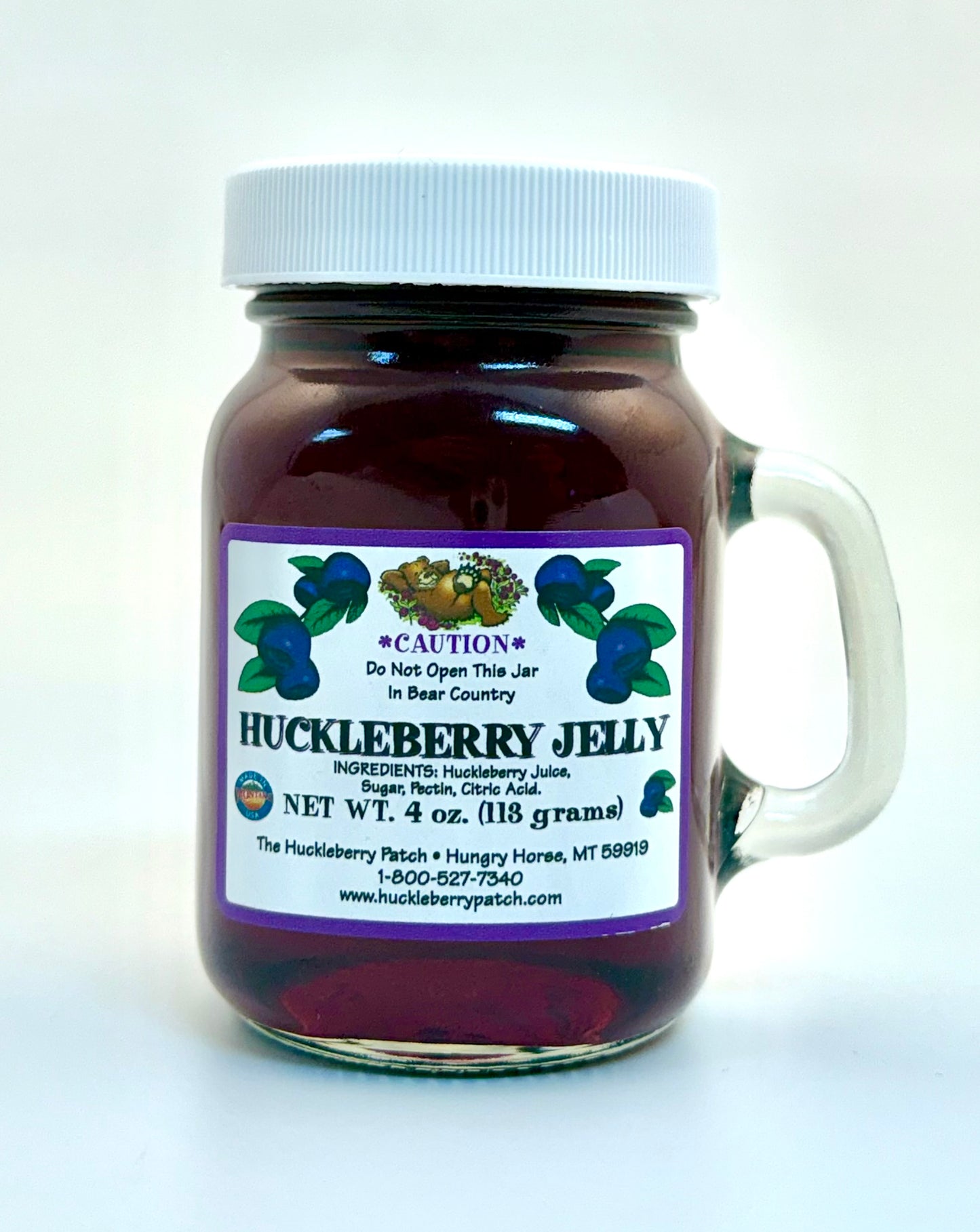 Classic 4oz jar of huckleberry jelly with front label and white lid