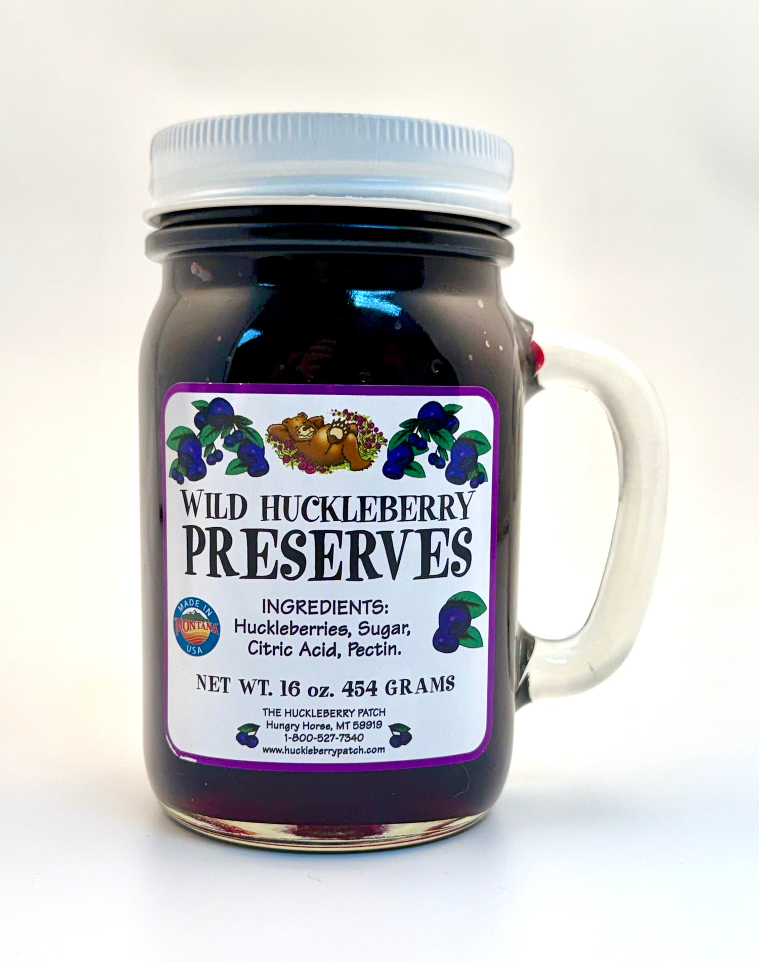 Large 16oz jar of huckleberry preserves filled to the top with berries