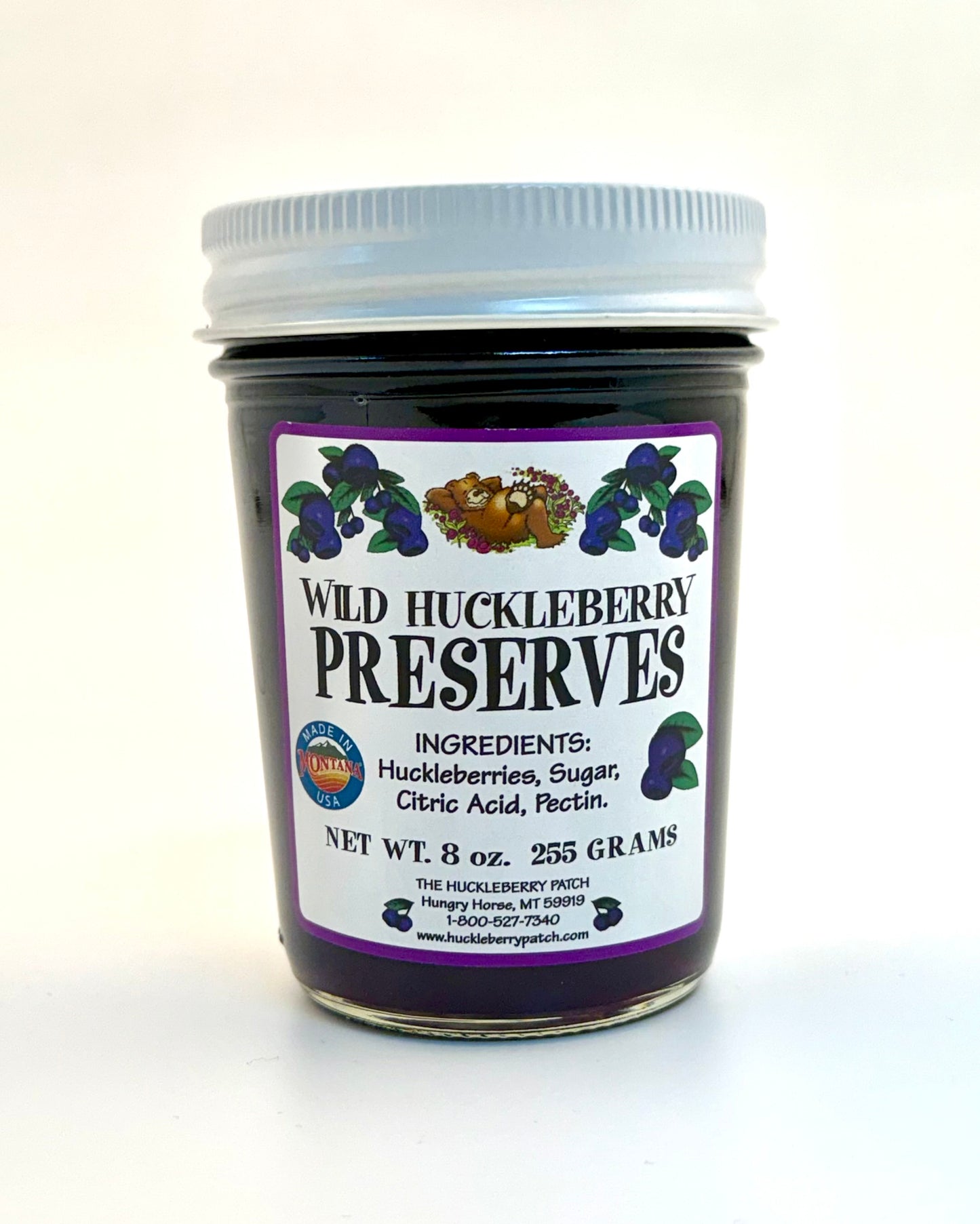 8oz jar of huckleberry preserves with fruit chunks visible through glass