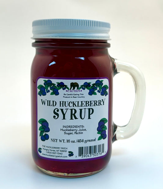 Large 16oz bottle of huckleberry syrup with screw cap and label wrap