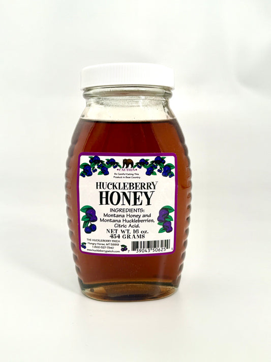 Smooth sweet huckleberry honey in large jar