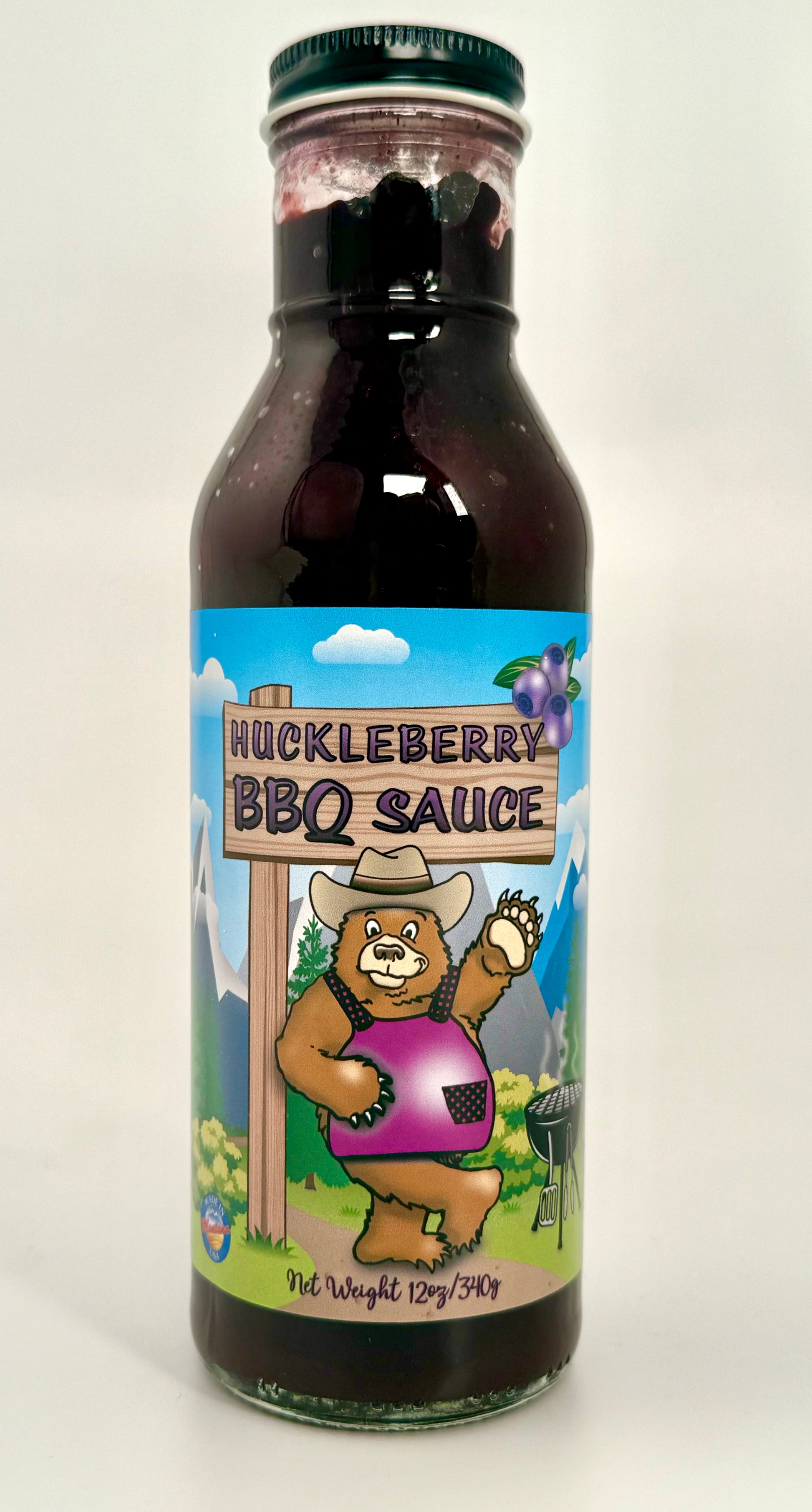 Sweet Smokey huckleberry sauce in glass bottle